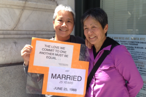 After 25 years, Trinity and Desiree are finally able to get married. They carried this sign around to tell their story and explain their happiness. Photo: Alexandra Hsieh and Gautami Sharma